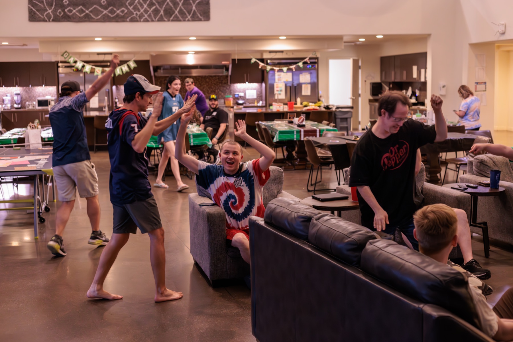 A resident celebrating in the Treasure House common room